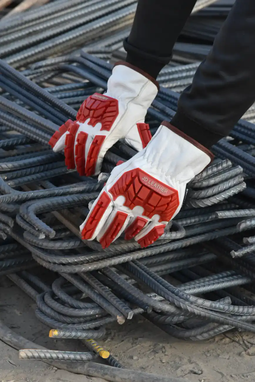 Gloved hands handling steel rebar