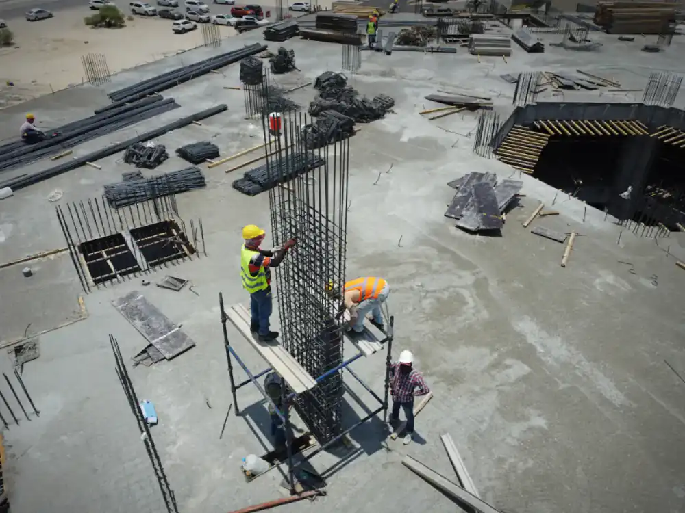 Aerial view of a construction site with steel fixers at work