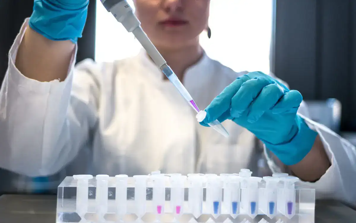 Lab technologist using a pipette