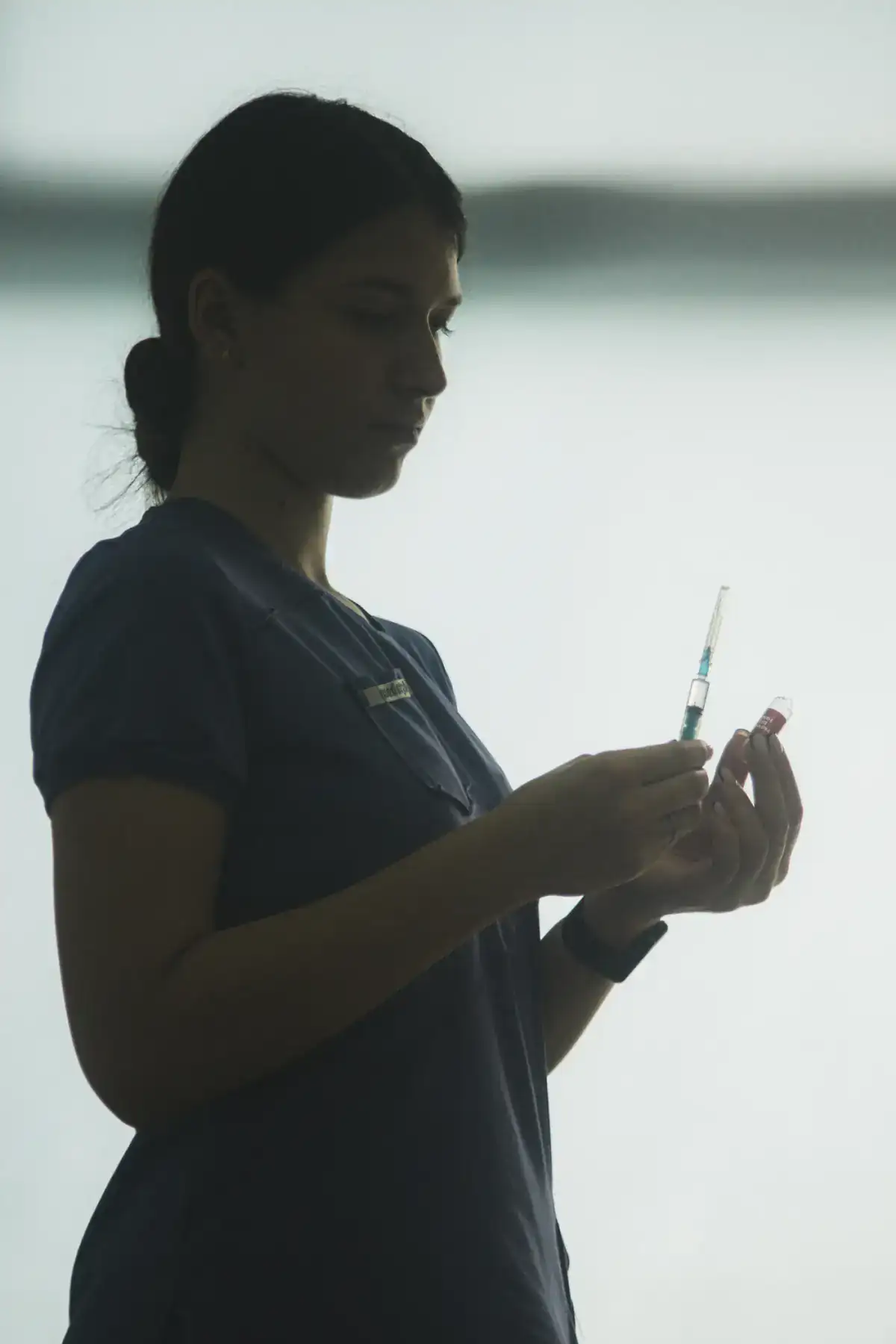 Nurse preparing a syringe