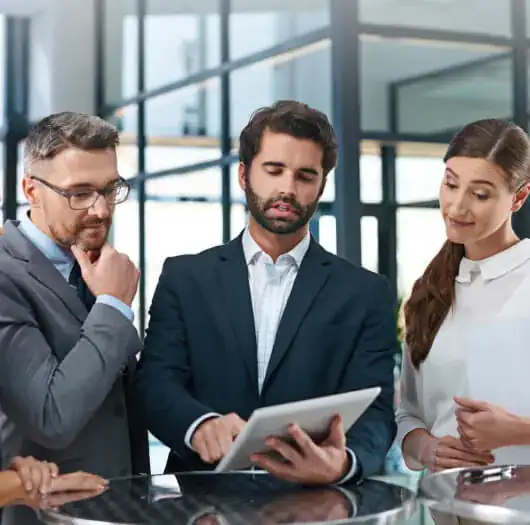 Professionals reviewing a project on a tablet