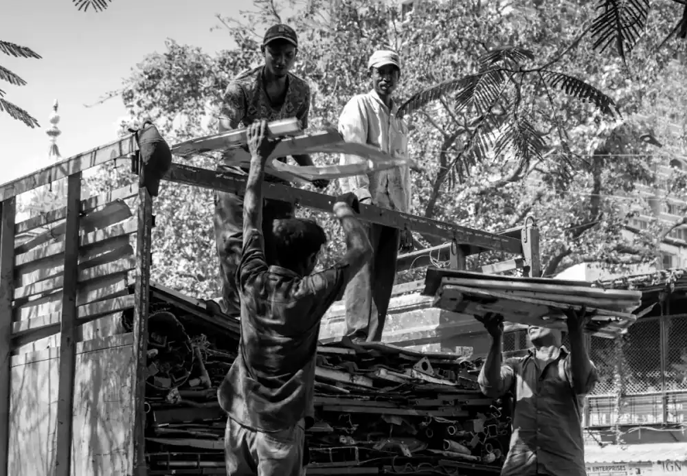 Workers loading timber onto a truck