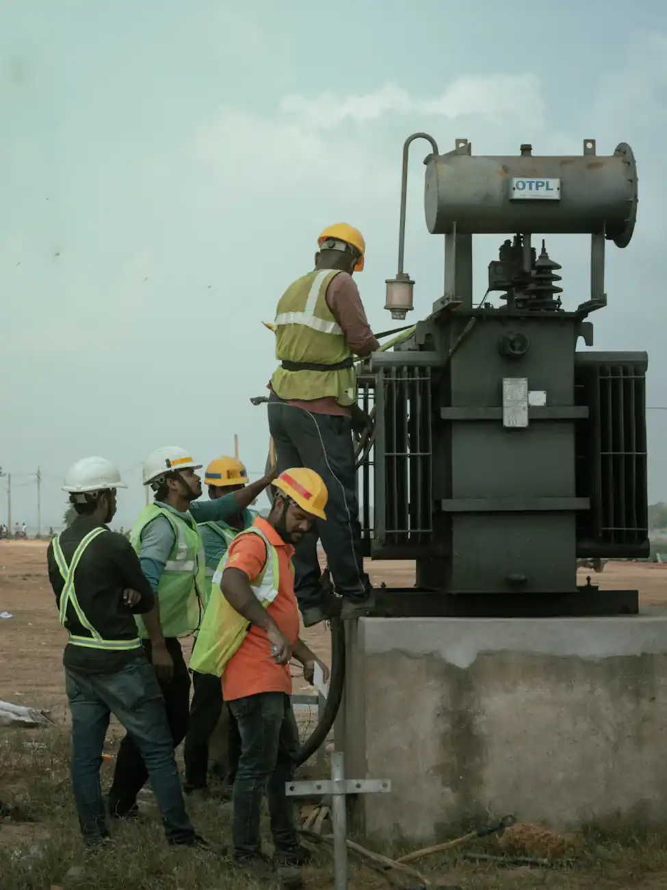 Indian site crew in hard hats at a power installation