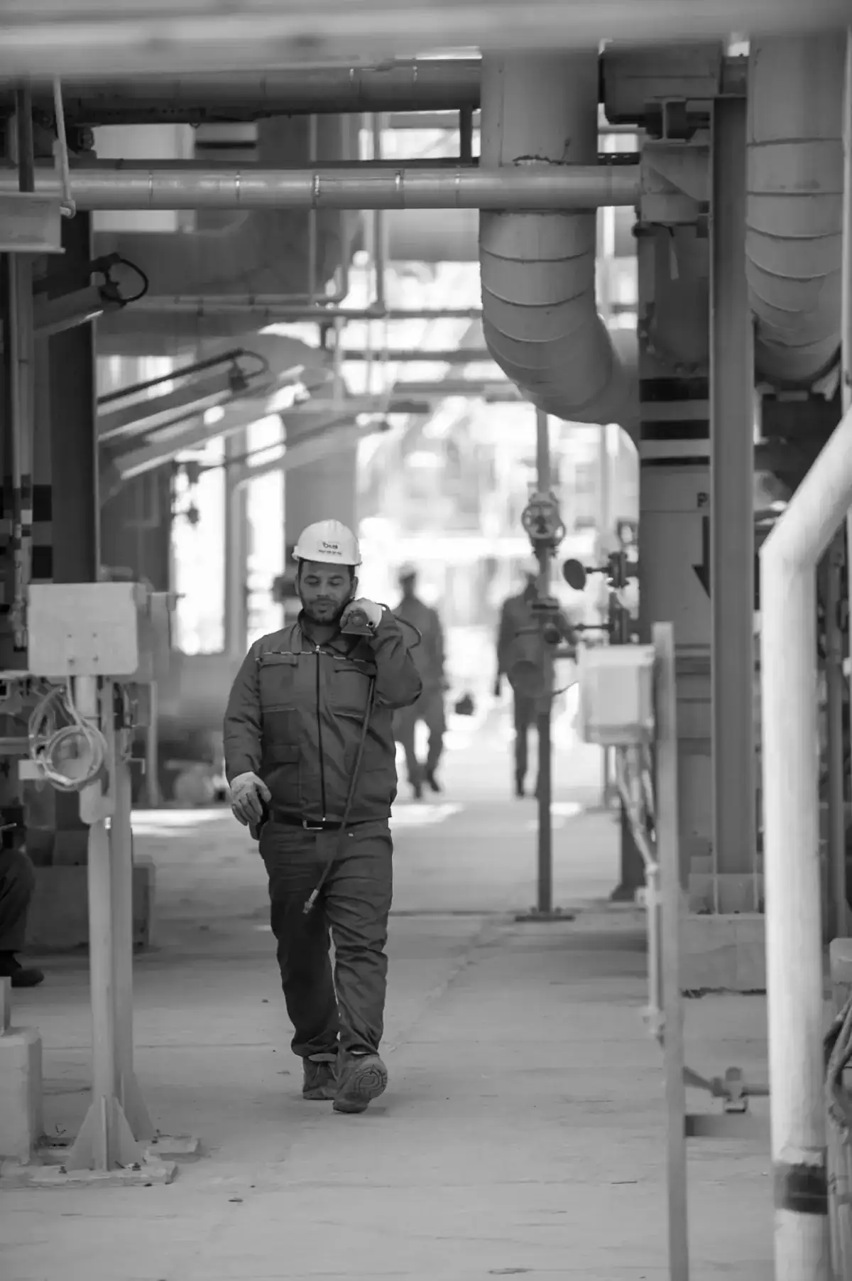 Plant worker walking through a processing unit