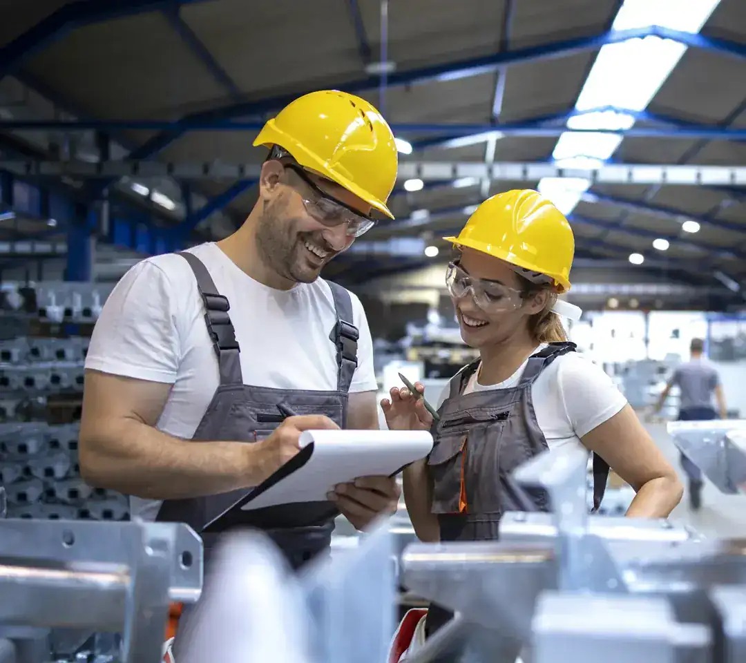 Technicians in hard hats on a factory floor