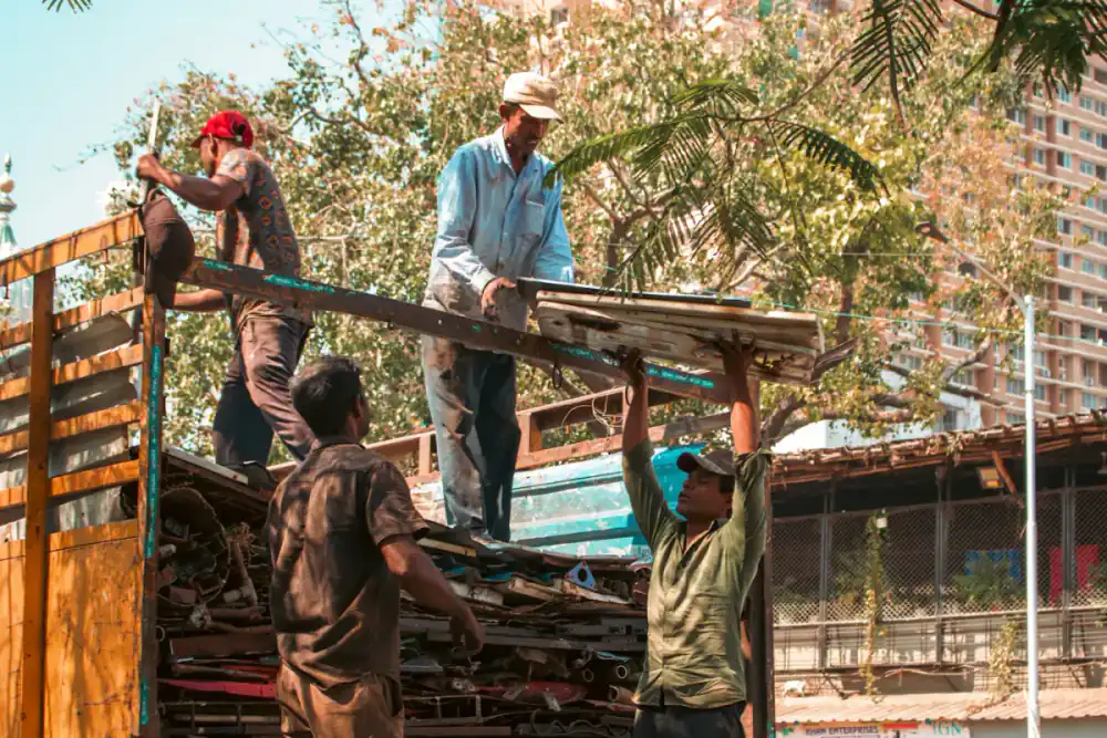 Workers loading timber onto a truck