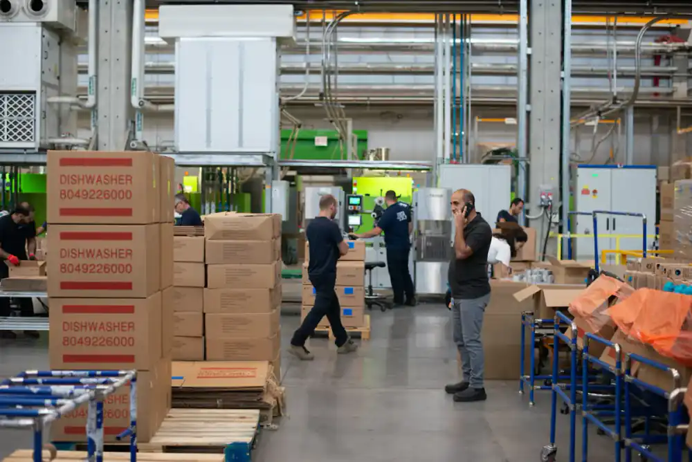 Warehouse staff packing and stacking boxes